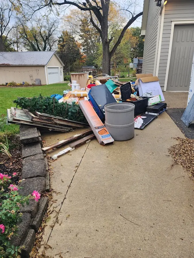 Dumpster being loaded with debris for Residential Dumpster Rental in Humble